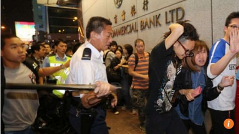 Retired Hong Kong policeman charged with assault for striking bystander during Occupy protests
