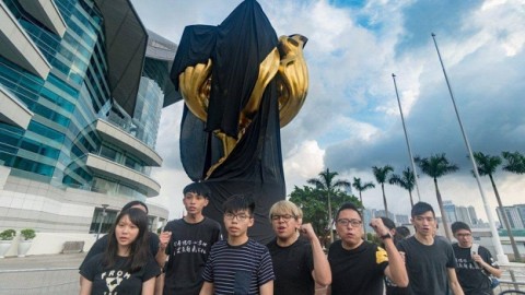 Joshua Wong and other activists cover iconic Golden Bauhinia statue in black cloth ahead of Xi Jinping visit