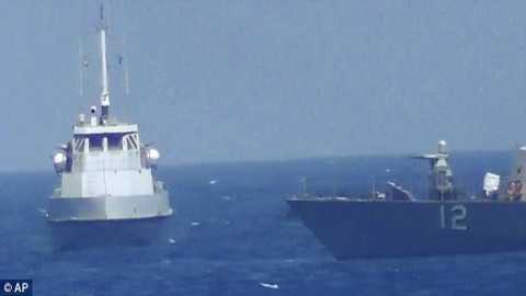 US Navy ship fires flares at an Iranian patrol boat in the Persian Gulf as Tehran condemns 'hostile' sanctions on its missile program passed by Congress