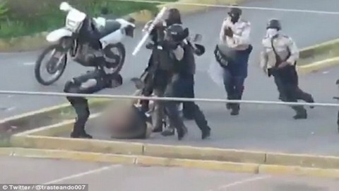 Horrific footage 'shows Venezuelan security forces brutally battering an opponent' as UN claims Maduro's men have killed dozens by using 'excessive force' to crush protesters