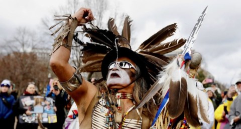 Little Thunder, a traditional dancer and indigenous activist from the Lakota tribe, dances as he demonstrates in front of the White House during a protest march and rally in opposition to the Dakota Access and Keystone XL pipelines. Photo: Kevin Lamarque / Reuters