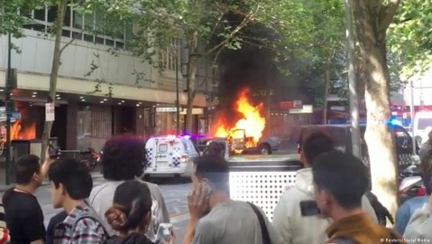 A burning car is seen on Bourke Street in Melbourne at the time of the knife attack. Photo: Reuters