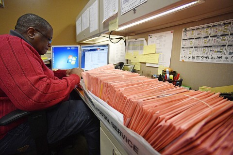 A Fulton County election worker counts provisional ballots November 7 in Atlanta. Photo: Mike Stewart/AP