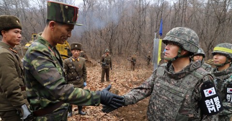 A South Korean military officer and a North Korean military officer shake hands near the demilitarized zone separating the two Koreas on November 22. Photo: South Korean Defense Ministry via Reuters