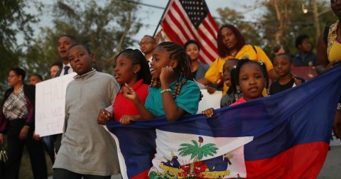 Children march with the Haitian and American flags. Photo: Joe Raedle/Getty