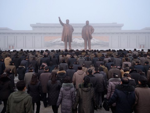 Pyongyang residents prepare to bow before statues of Kim Il Sung and Kim Jong Il during National Memorial Day on Sunday. Photo: AFP/Getty Images )