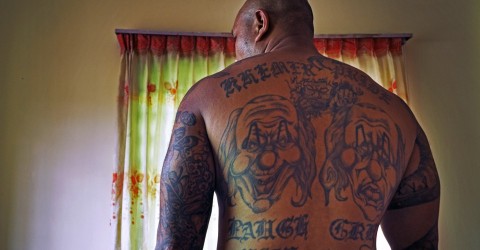 Thuch Sek's tattoos are an eclectic mix of his American and Cambodian identities. The tattoo that consumes his back reads: 