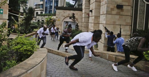 Civilians flee the Nairobi hotel complex where terrorists killed at least 14 people on Tuesday. Photo: Khalil Senosi/AP