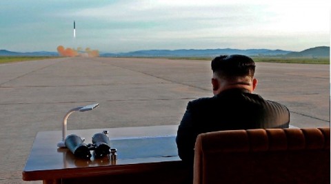 North Korean leader Kim Jong-Un watches the launch of a Hwasong 12 missile
