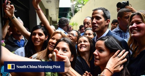 Venezuelan opposition leader and self-proclaimed interim president Juan Guaido poses for a picture with supporters. 