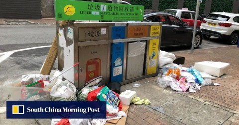A collection point for recyclable waste overflows with rubbish. 