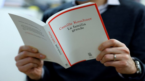 man-reads-camille-kouchners-book