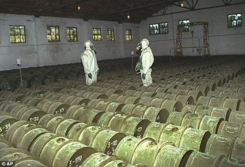 Two Russian soldiers make a routine check of metal containers with toxic agents at a chemical weapons storage site in the town of Gorny, 124 miles south of the Volga River city of Saratov