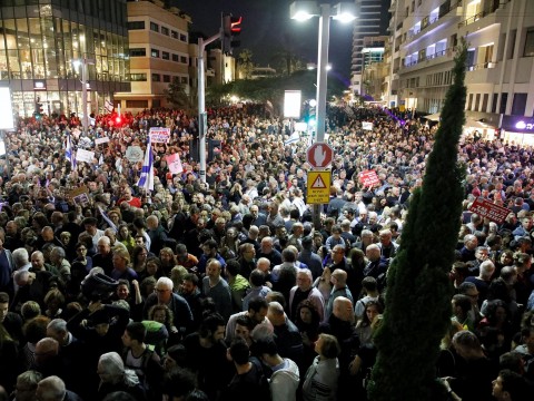 Israeli police question Netanyahu ally as thousands protest against corruption
