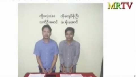 In this image released by the Myanmar Ministry of Information and broadcast by Myanmar's MRTV on Dec. 13, 2017, Reuters reporters Wa Lone, left, and Kyaw Soe Oo stand handcuffed in Myanmar