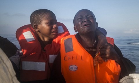 Up to 25,000 Nigerians have been held in slave prisons and sex camps in Libya while trying to get to Europe, it emerged today. Pictured: Two Nigerian migrants are rescued in the Mediterranean Sea (AP)