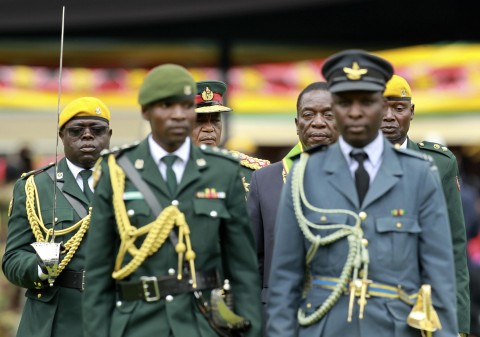 Emmerson Mnangagwa (center r.) with army Gen. Constantino Chiwenga, inspects a military parade after being sworn in as Zimbabwe's president Nov. 24. The military's stunning and prominent role in overthrowing Robert Mugabe and the way the bloodless coup was conducted have raised questions about whether troops will return to their barracks so readily. (AP/File) Power leads to corruption, and the people of U
