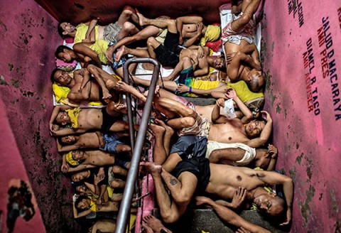 File photo shows inmates of the Quezon City jail sleeping on the steps of a staircase. There are 3,800 inmates at the jail, which was built six decades ago to house 800 prisoners.