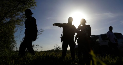 Customs and Border Patrol agents pick up immigrants suspected of crossing into the United States illegally along the Rio Grande near Granjeno, Texas, in August 2017. Eric Gay/AP