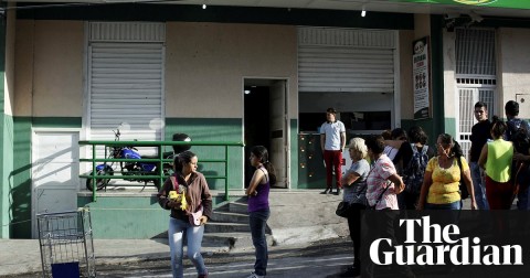  A supermarket with its security shutters partially closed as a precaution against looting in San Cristóbal. Photograph: Carlos Eduardo Ramírez/Reuters