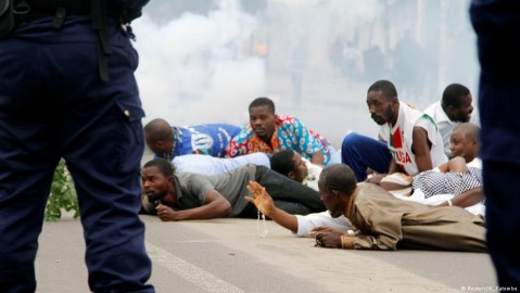Protesters lie in the street amid tear gas. Photo: N.Katombe / Reuters