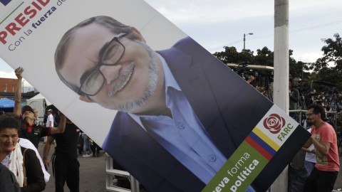 Supporters set up a placard of Rodrigo Londono, known as Timochenko, the presidential candidate of the political party launched by former rebels of the FARC, during an event to present the party's candidates to Congress in Bogota, Jan. 27, 2018. Photo: AP