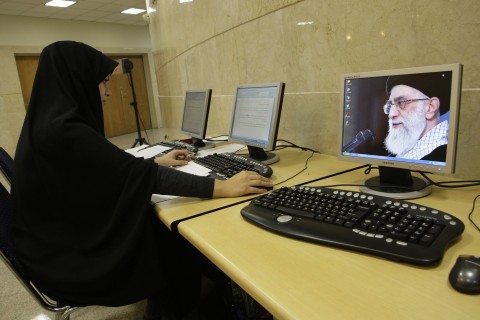 Iranians work in an internet cafe in central Tehran. Photo: Vahid Salemi/AP
