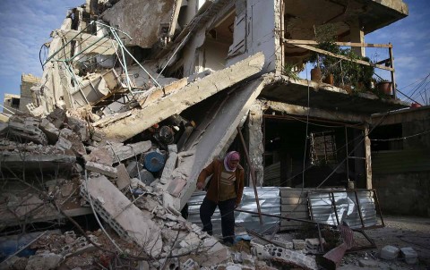 A person inspects a damaged building in Douma, Eastern Ghouta, Damascus, Syria, February 20, 2018. (Reuters / Bassam Khabieh)