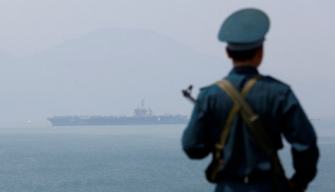 A Vietnamese soldier keeps watch as the aircraft carrier USS Carl Vinson arrives off the port of Da-nang. Photo: Reuters