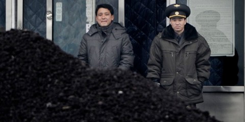 A North Korean military officer (R) and a North Korea man (L) standing behind a pile of coal along the banks of the Yalu River in the northeast of the North Korean border town of Siniuju. Wang Zhao/AFP/Getty Images