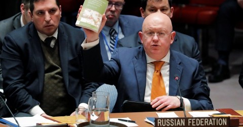 Russian Ambassador to the UN Vasily Nebenzya reads from 