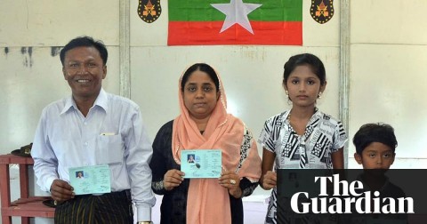 Members of a Rohingya family show their ID cards. Photograph: Ministry of Information
