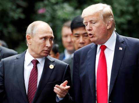 Vladimir Putin specks with Donald Trump during a short walk