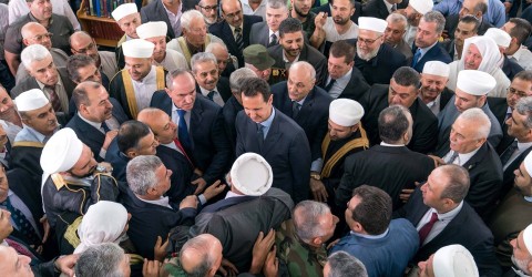 Assad greets his supporters during Eid al-Fitr prayers at a mosque in Tartous. Photo: Sana Sana / Reuters
