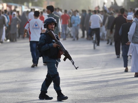Afghan security patrols at the scene of a suicide attack in Kabul, Afghanistan ( EPA )