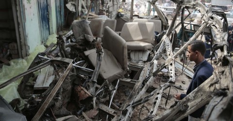 A man inspects the wreckage of a Saudi air strike on a crowded bus in Yemen. Photo: Hani Mohammed / AP