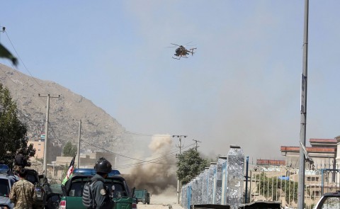 An MD 530F military helicopter targets a house where suspected attackers were hiding in Kabul, Afghanistan. Photo: Rahmat Gul / AP