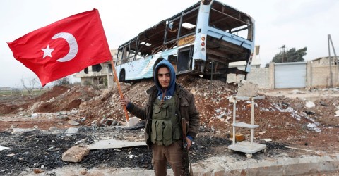 A Free Syrian Army fighter holds a Turkish flag earlier this year. Photo: Osman Orsal / Reuters