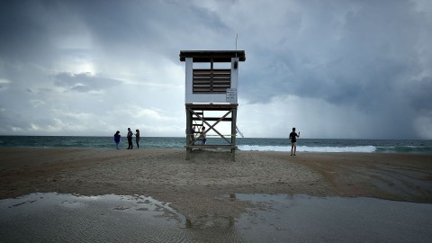 People stand near a lifeguard stand as Hurricane Florence approaches, on Sept. 11, 2018, in Wrightsville Beach, N. Photo: Mark Wilson, Getty Images