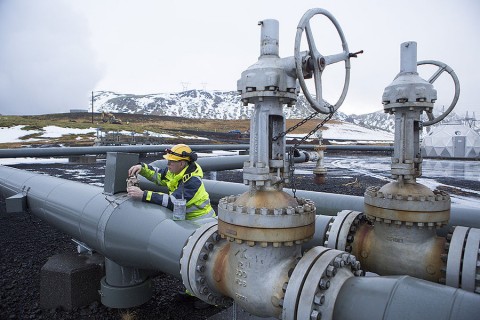A worker checks a pipe beside a carbon injection site well near Reykjavik Energy’s Hellisheidi Geothermal Power Plant outside Reykjavik, Iceland. Photo: Melanie Stetson Freeman