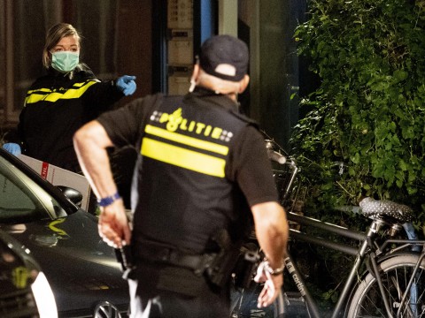 Officers inspect a house associated with an alleged terrorist in Holland. Photo: AFP
